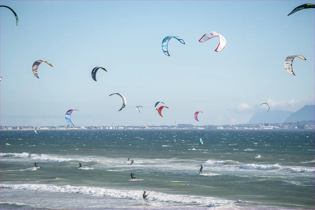 A packed lineup of kites over the water